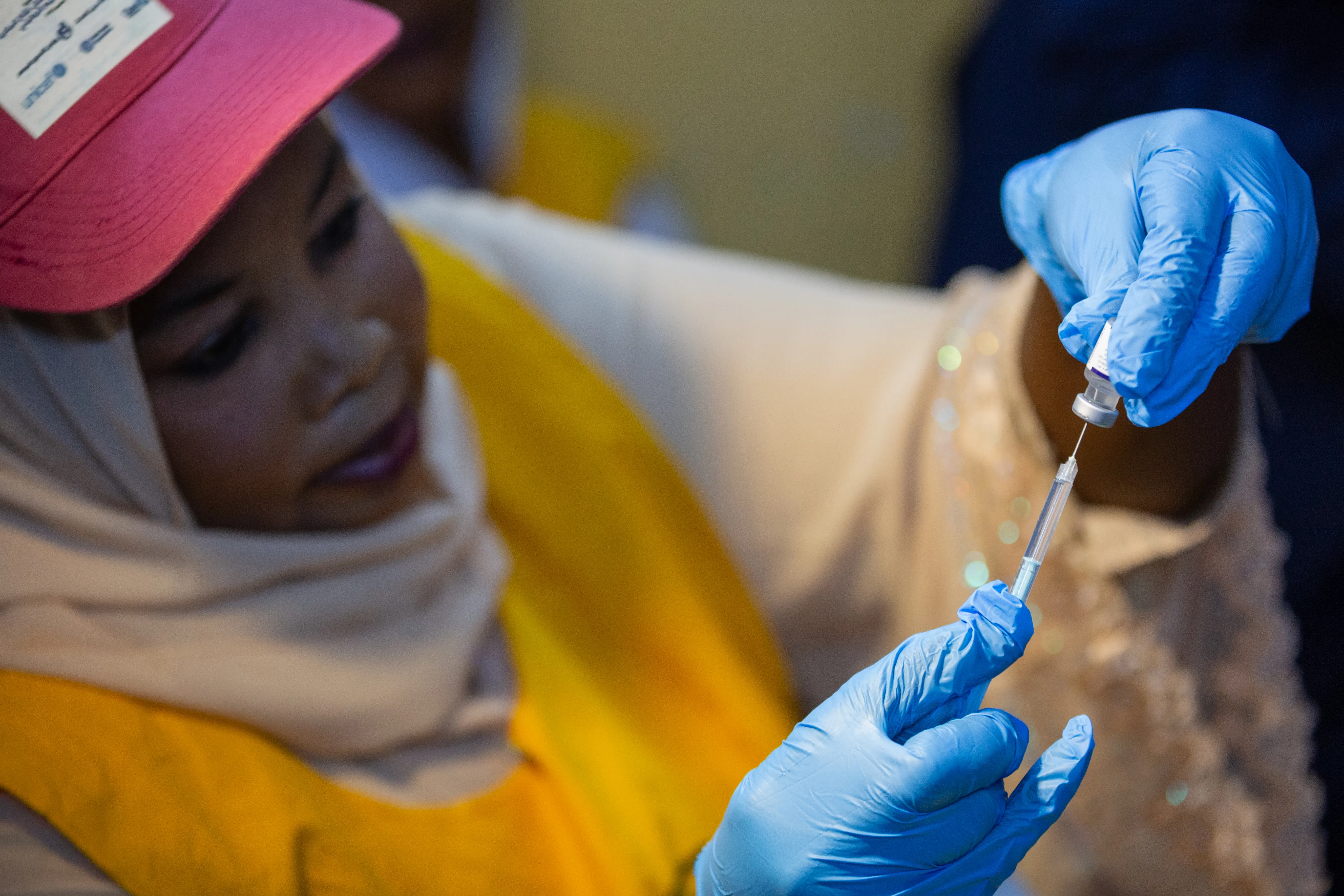 Health worker prepares malaria vaccines in Sudan