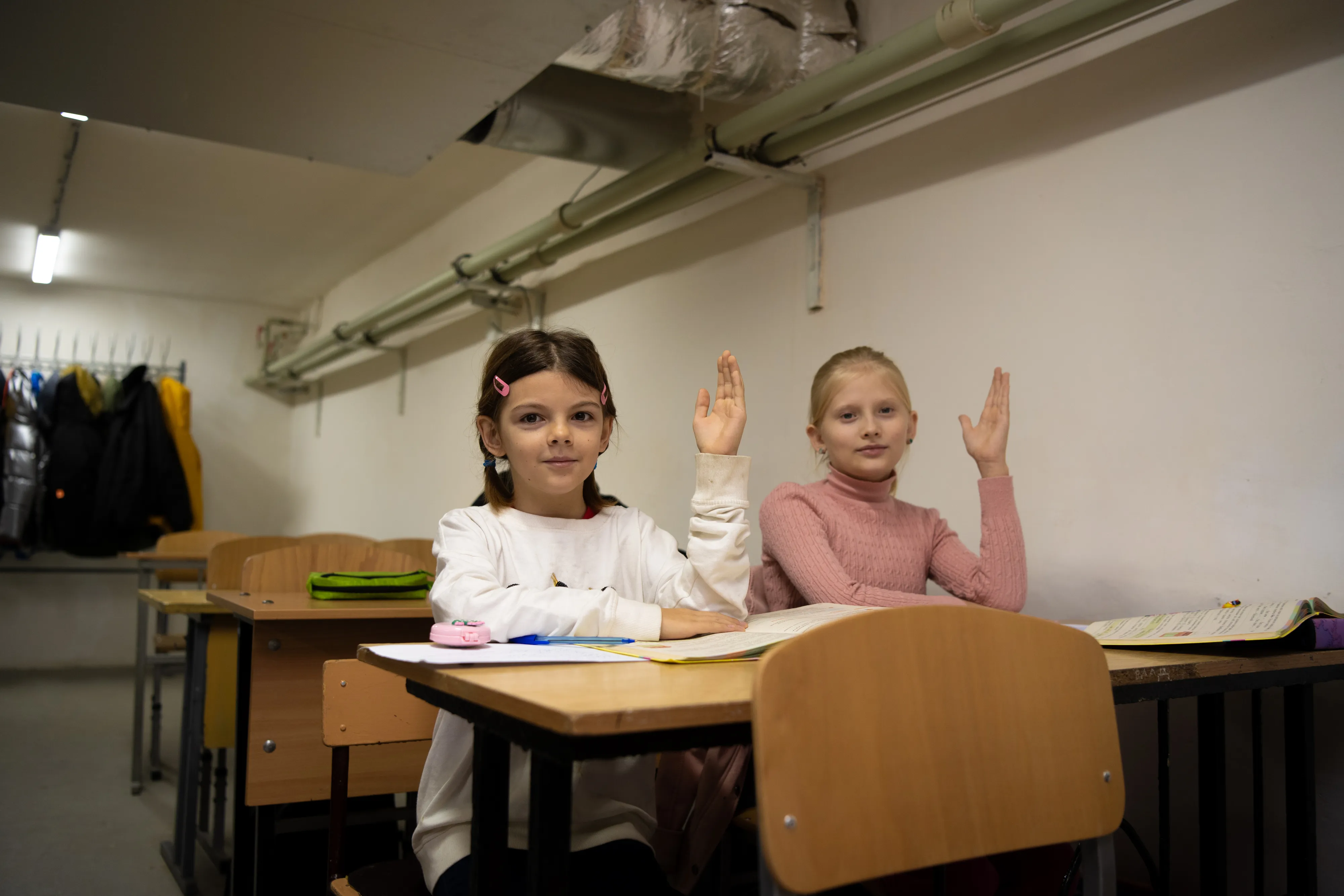Fourth-grade students attend a lesson in a basement classroom.