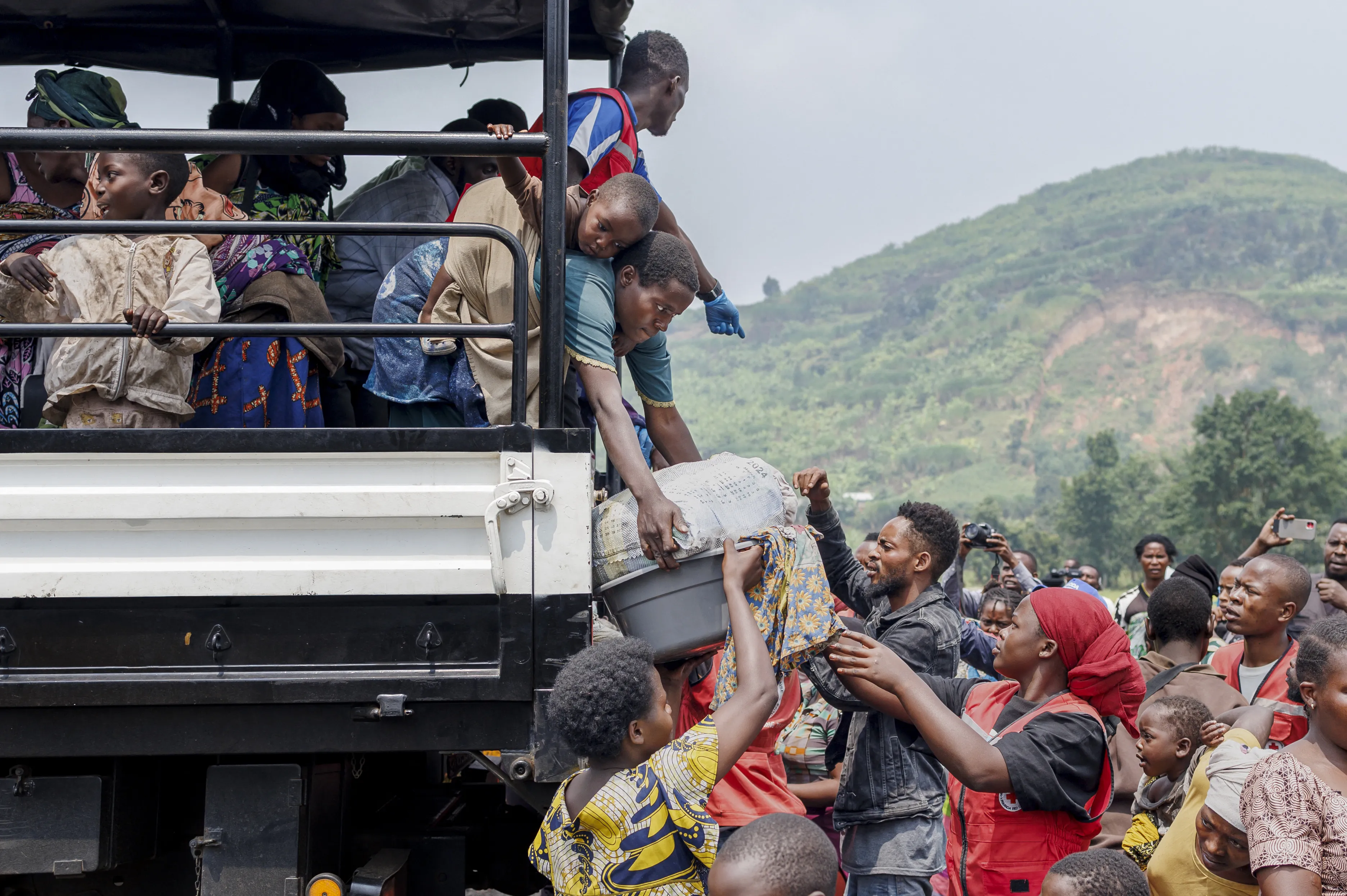 Congolese refugees fleeing ongoing clashes in eastern Democratic Republic of Congo carry their belongings as they arrive at the Rugerero transit camp in Gisenyi on January 28, 2025.