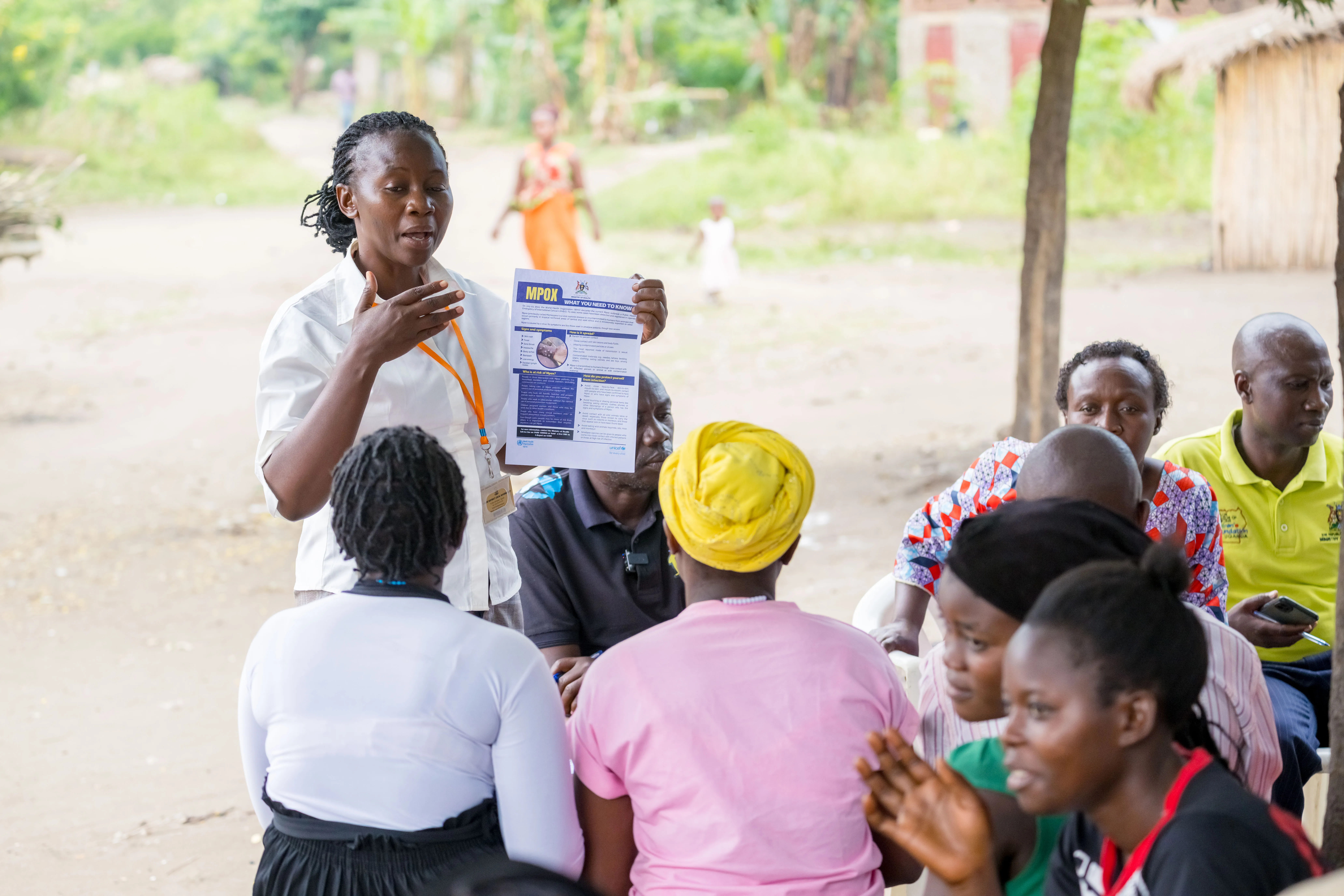 In a community outreach event, Ms. Mbambu Agnes, a Senior Health Educator from Kasese District, educates residents of Kamukumbi Mughongo Village.