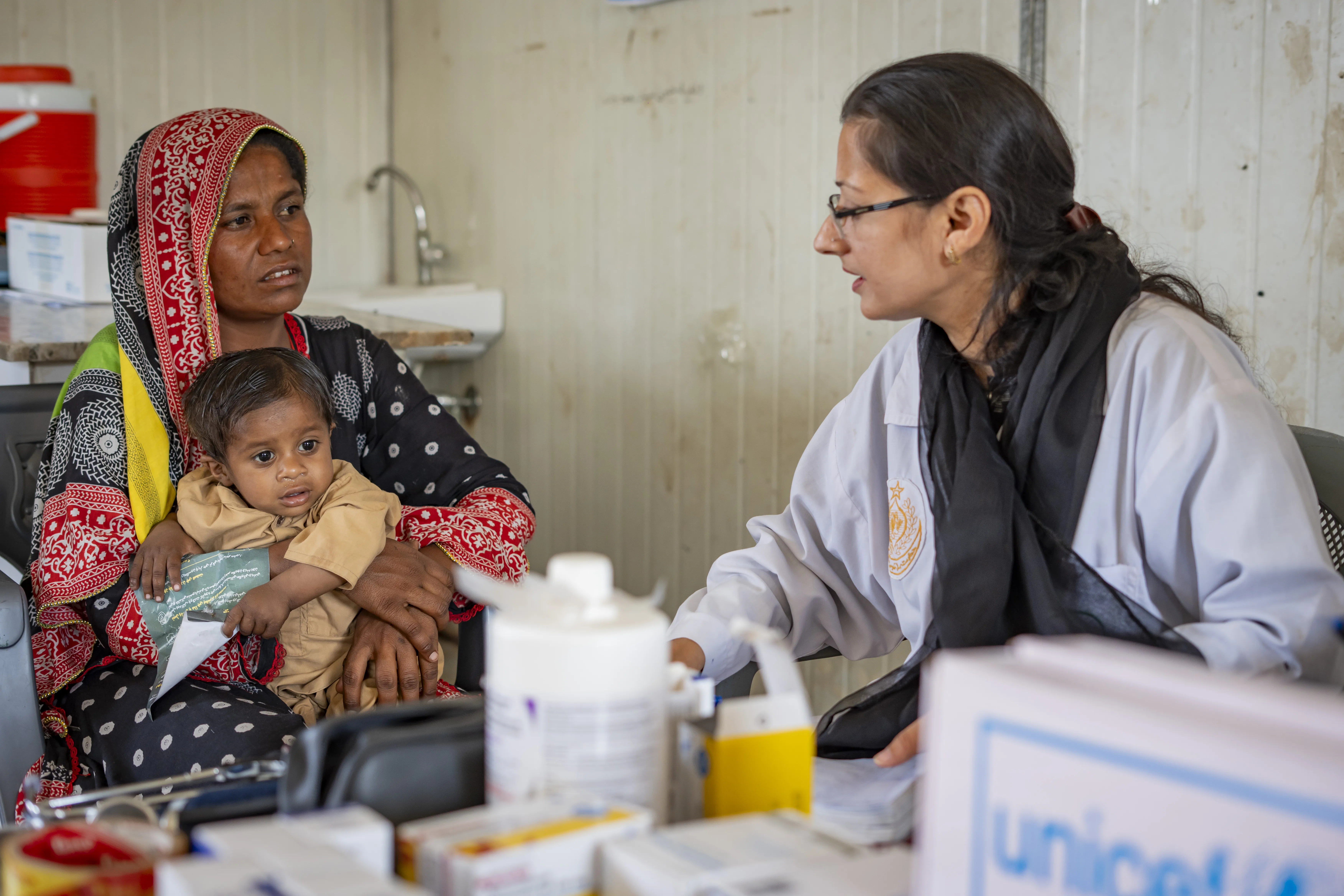 A mother with newborn getting doctor's assessment in Pakistan