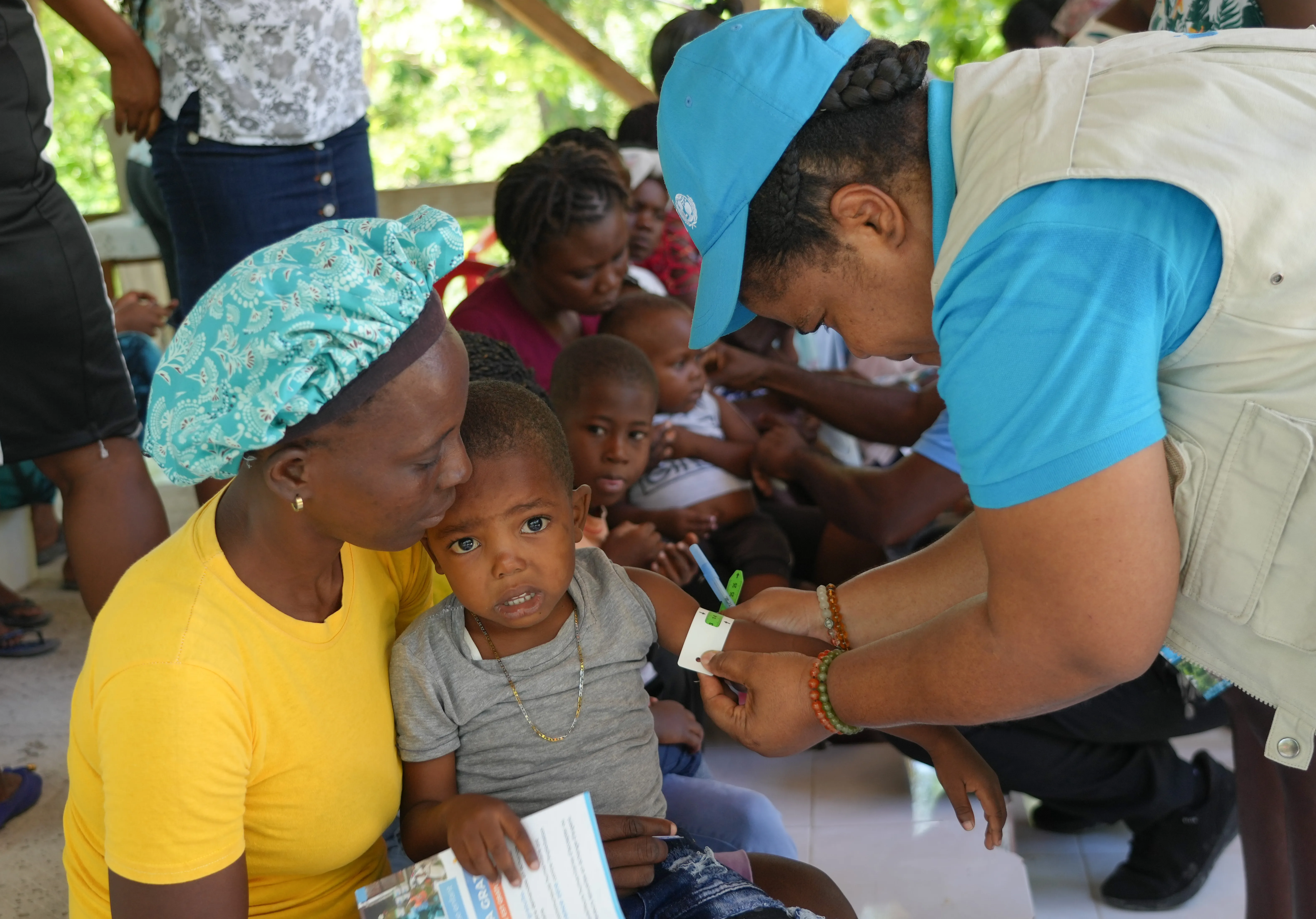 Child is screened for malnutrition at UNICEF-supported mobile site in Haiti