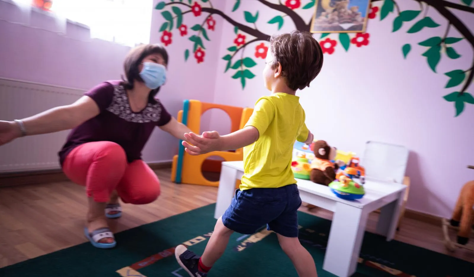 Childcare worker and child at a centre in Albania.