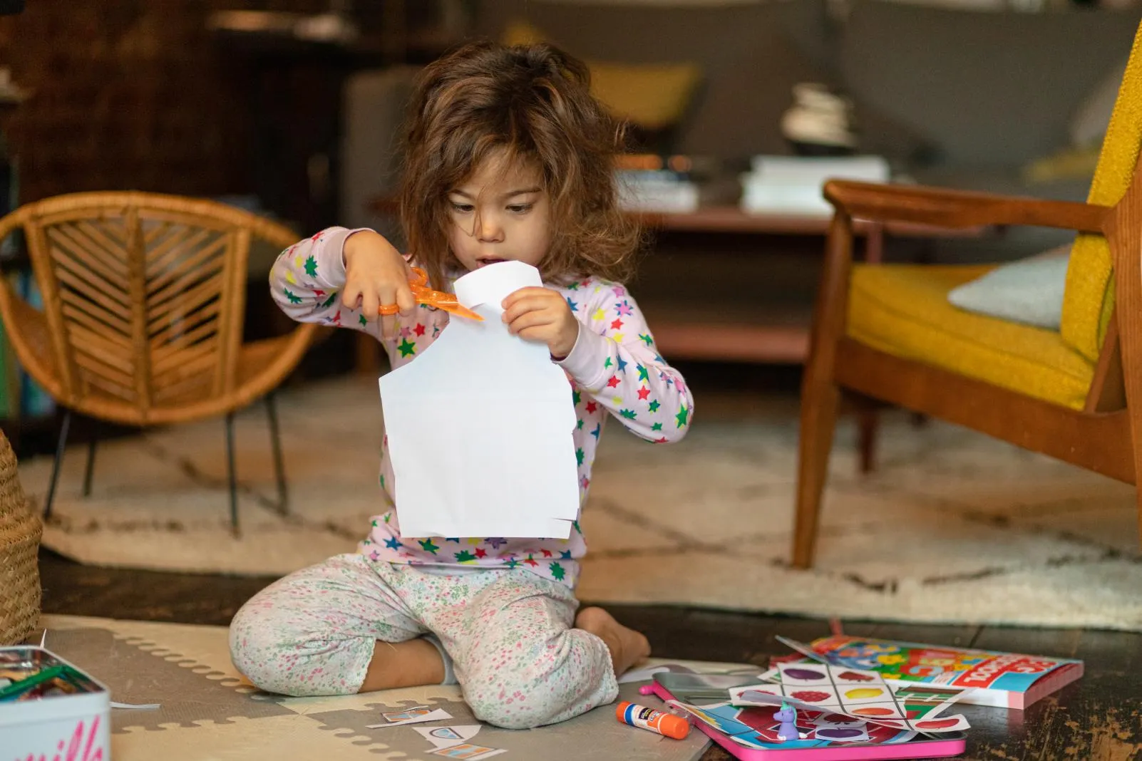 A little girl does crafts at home during COVID-19 lockdowns.