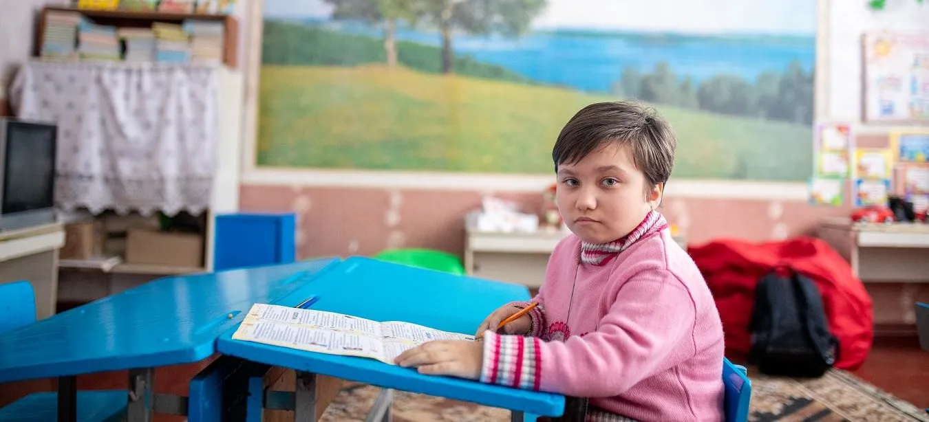 A girl sits in a classroom in Eastern Ukraine.