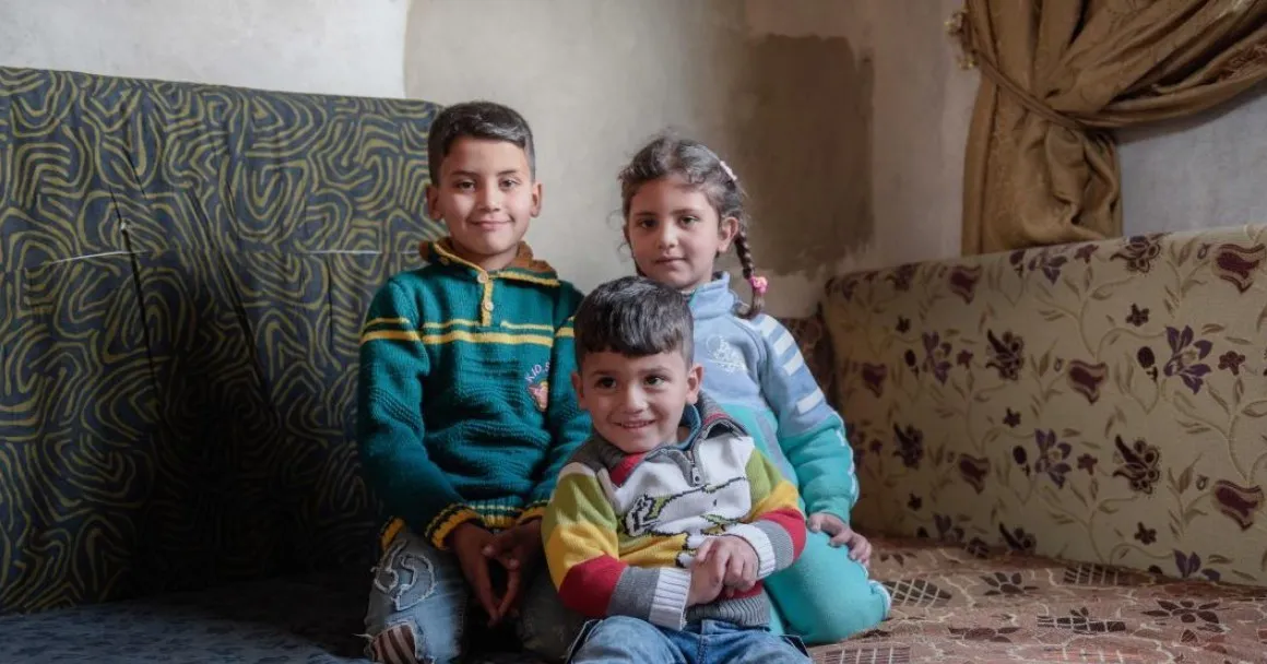 Haifa's children pose inside their temporary home