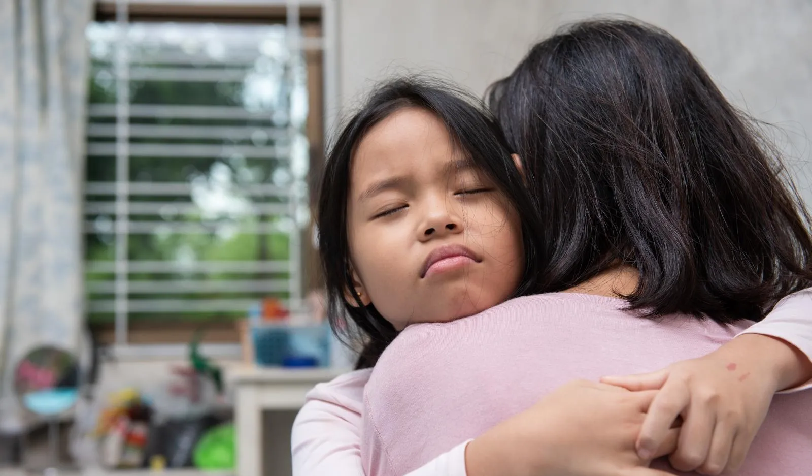 A girl hugs her mother.