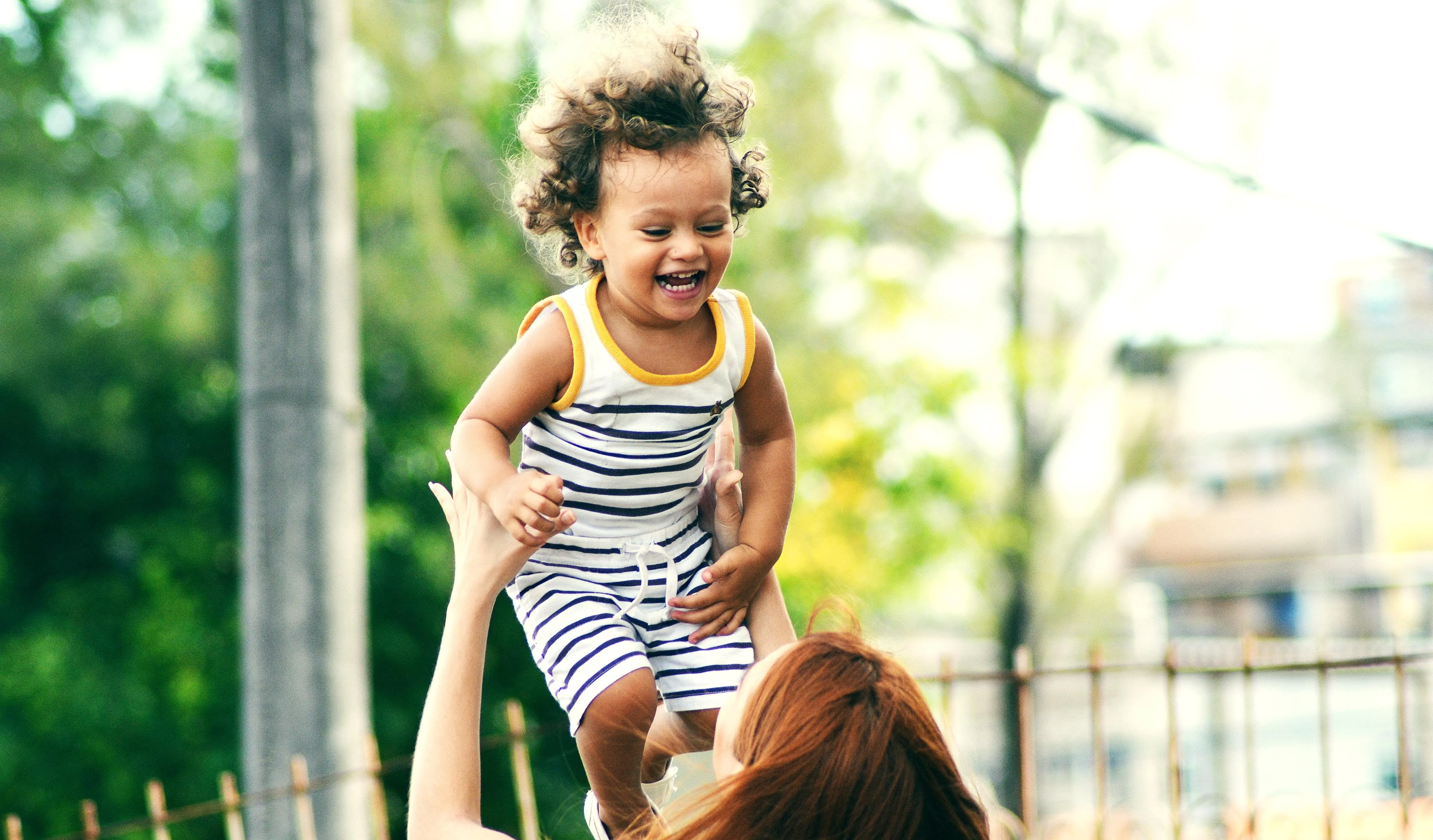 Mother lifting her child in the air