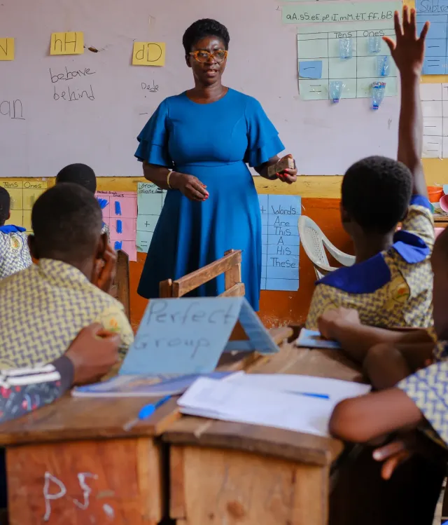 A woman is teaching a class of students
