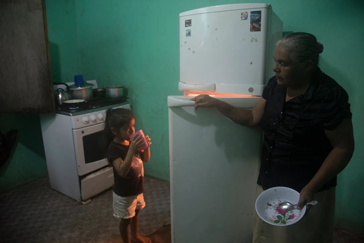 Allizon, with her great-grandmother, drinks a beverage at home. 