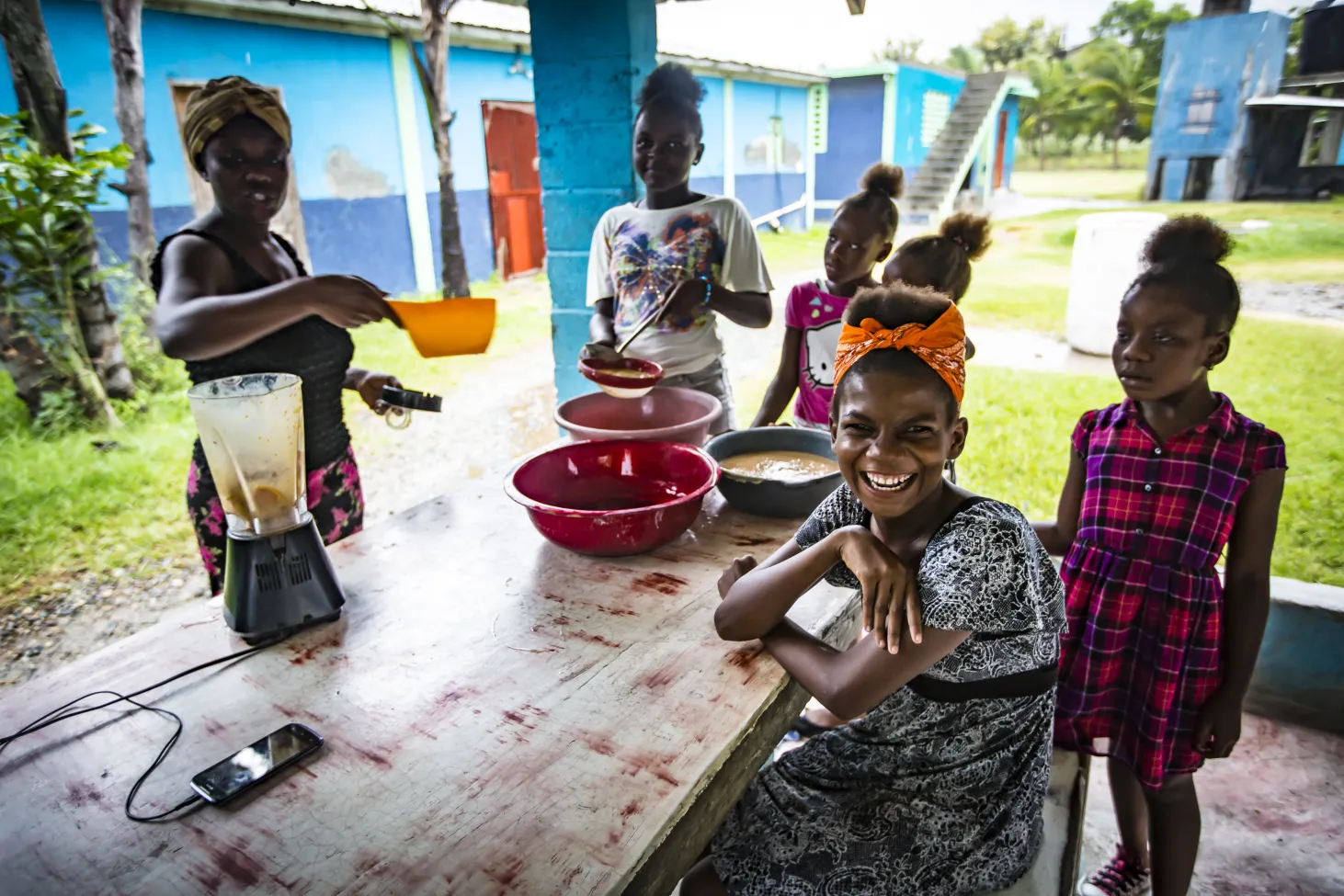 children and parents take a moment to laugh and smile while preparing for the storm