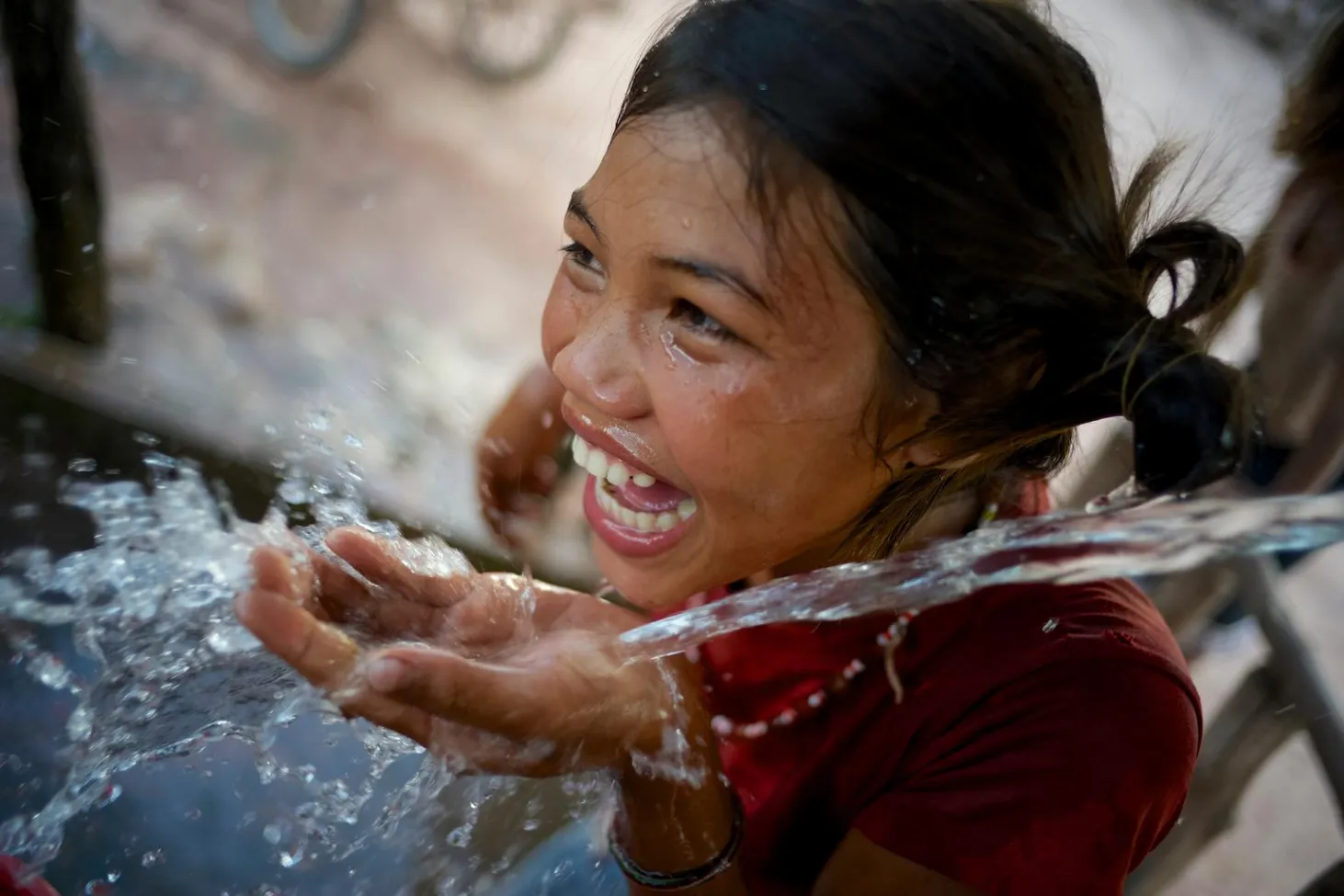girl drinking water in Laos