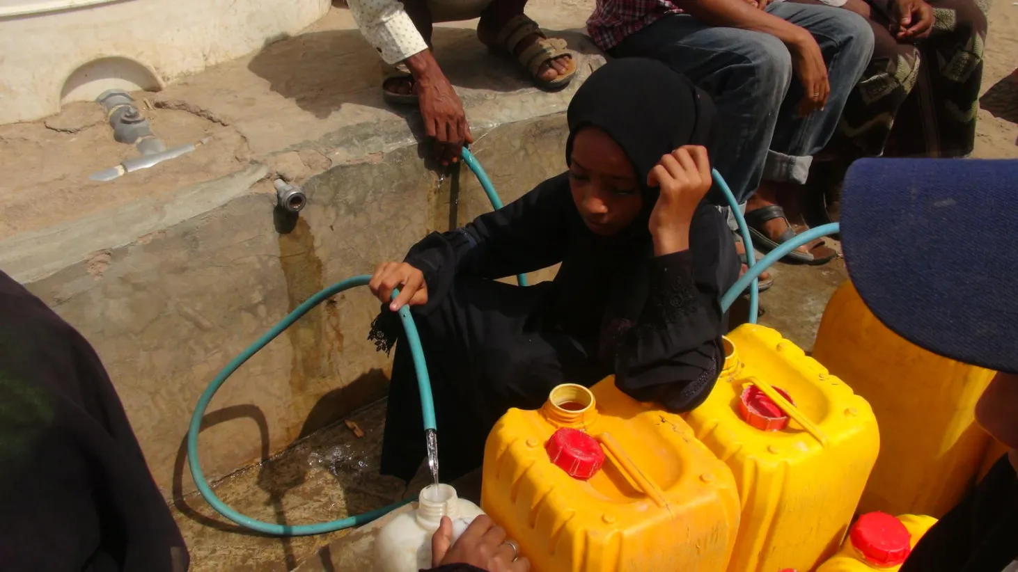 yemen girl getting water