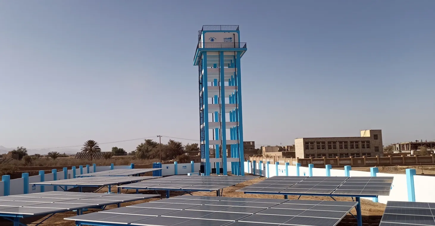 A solar-powered water system featuring a tower tank and solar panels in Yemen.