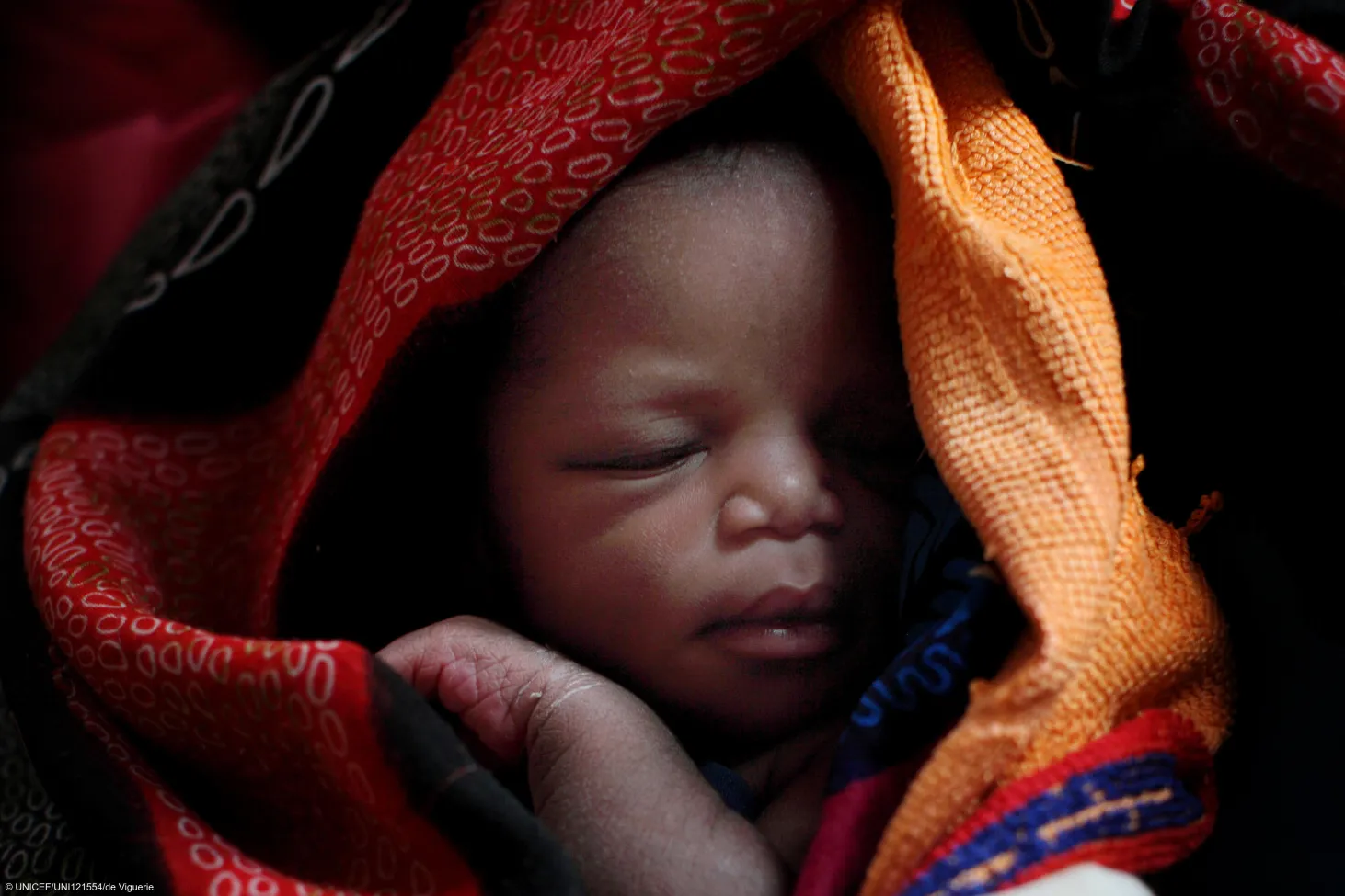 A newborn baby sleeps,  wrapped in warm blanket in the city of Wau, capital of Western Bahr al Ghazal State in Southern Sudan.
