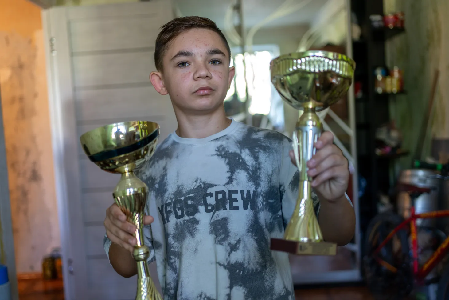 13-year-old Bohdan shows his trophies for the dancing competitions.
