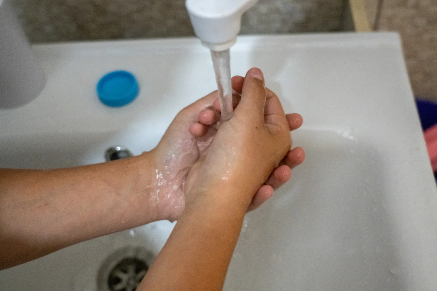 13-year-old Bohdan is washing his hands.