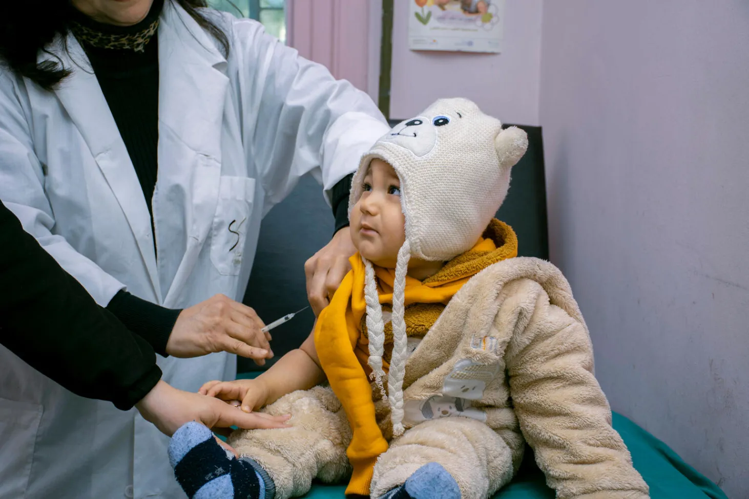 A baby gets vaccinated in a clinic.