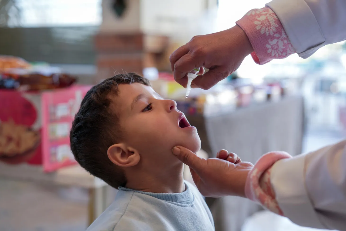 A child recieves a oral vaccine 