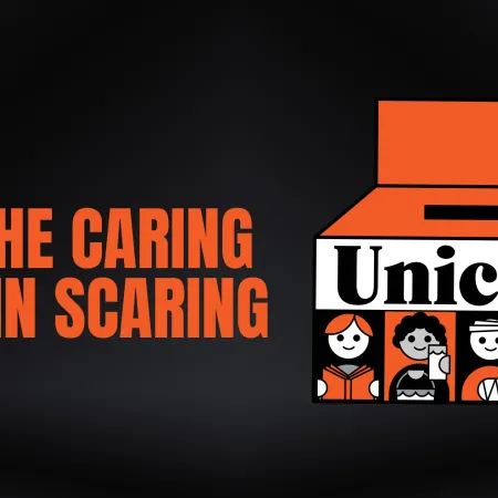 The image depicts UNICEF Canada's iconic Halloween box with the tagline " Put the caring back in scaring"