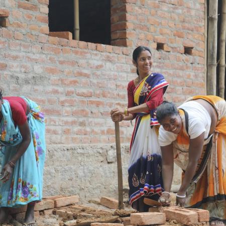 Three rani mistris work at digging a new toilet.