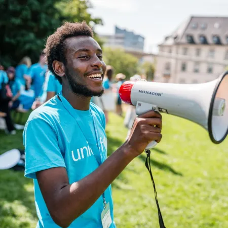 A youth speaking through microphone