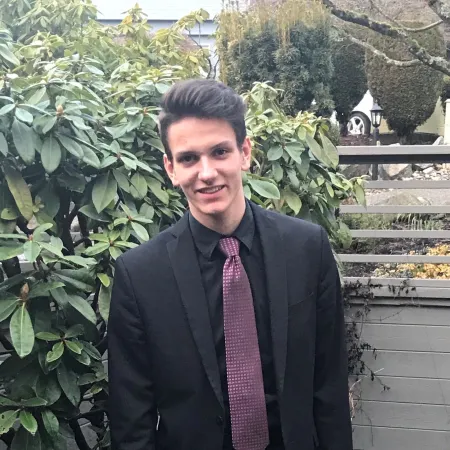 A photo of Augustin in a suit in his backyard, author of the blog