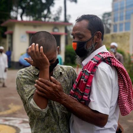 A man consoles his son who was just released from a youth detention centre for migrants.