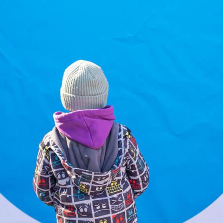 A child standing at a Blue Dot hub