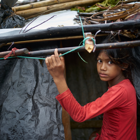 Young girl under shelter bracing for Cyclone Amphan