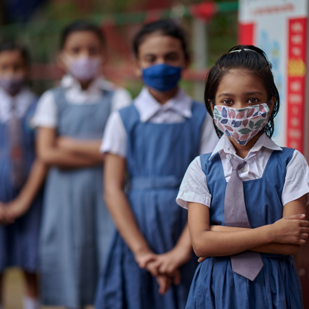 A group portrait of students wearing masks inside the school premises at Gandaria Mohila Shomity Government Primary School, Dhaka, Bangladesh on 12 September 2021.