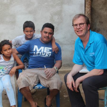David with a migrant family in Honduras.