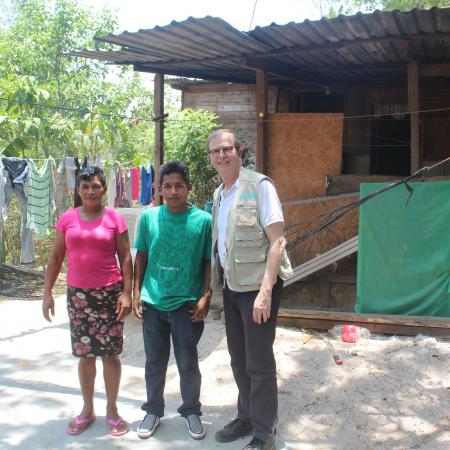 David poses with a migrant family in Honduras.
