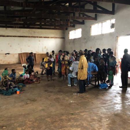 People wait at a temporary shelter in Gondola, Mozambique.