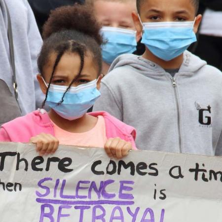 Two children hold a sign at a Black Lives Matter protest.