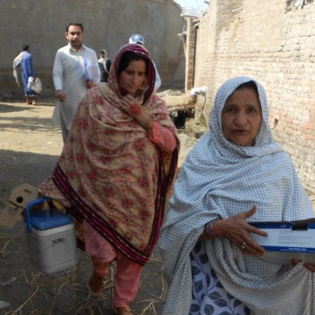UNICEF-supported "lady health workers" Jameela, right, and Shamul visit the village of Peer Jo Goth in Pakistan's Kambar District to vaccinate women of childbearing age against tetanus.