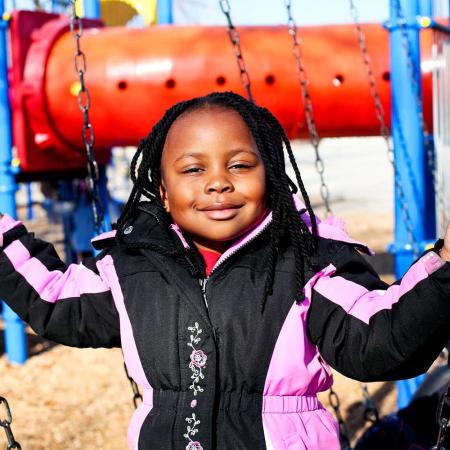  Happy child on playground swing set