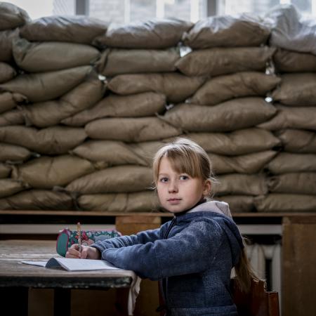 Lera Nagormay, 10, sits for a photograph in a classroom at school in Marinka, Donetsk Oblast, Ukraine.