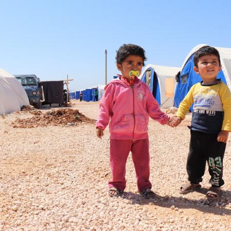 Children holding hands, Syria, 2018.