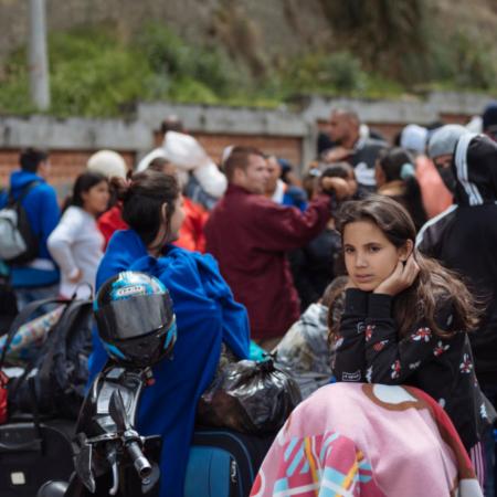 A migrant girl waits for processing