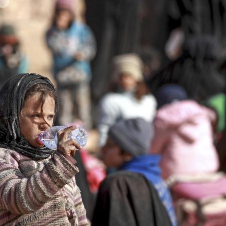 Girl forced to flee her home in Hajin, Syria