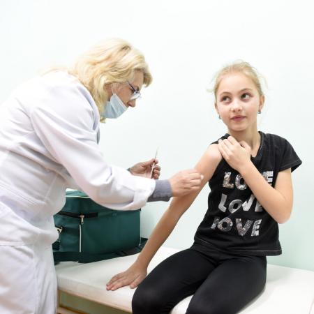 A young girl receives an MMR vaccine.
