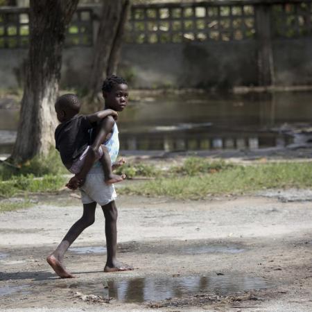 girl holds boy on her back