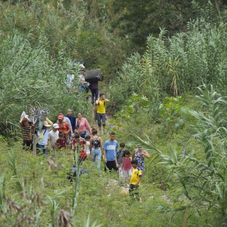 A group of migrants crosses an illegal path between Colombia and Venezuela.