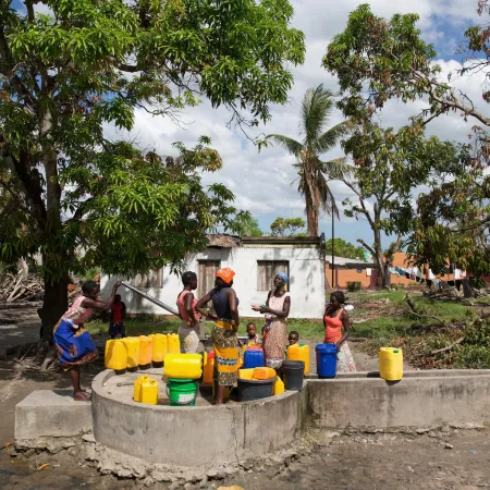 A woman fill jerricans at a community water point. 