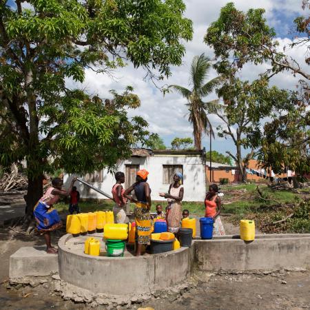 A woman fill jerricans at a community water point.