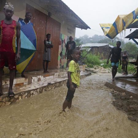 Boy stands in flooded streets in Pemba, Mozambique
