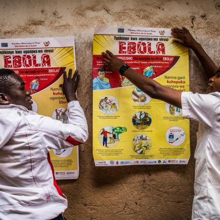 School children put up posters with ebola advisories.