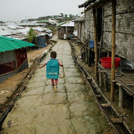 kid walk in rohingya camp during monsoon