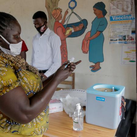 On 8 October 2020 at Gurei Health Care Centre in Juba, South Sudan, Elisabeth Abraham Loro, nurse and vaccinator, collects vaccines from a cold box.